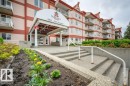 Multi-story residential building with a red and beige facade - 316 2011 137 Avenue, Edmonton, AB  - Outdoor With Balcony 