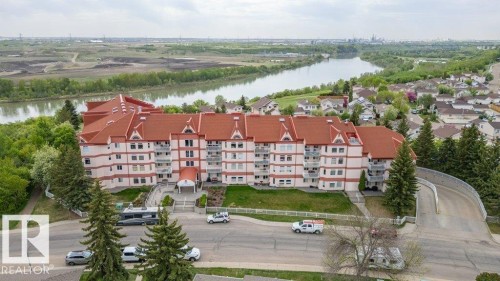 Five-story building featuring a prominent red roof and multiple balconies - 316 2011 137 Avenue, Edmonton, AB - Outdoor With View