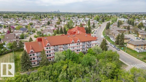 Multi-story residential building with a red peaked roofline - 316 2011 137 Avenue, Edmonton, AB - Outdoor With View