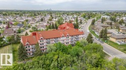 Multi-story residential building with a red peaked roofline - 