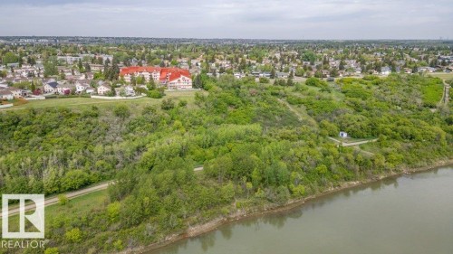 Expansive waterside property featuring dense mature trees and verdant landscaping - 316 2011 137 Avenue, Edmonton, AB - Outdoor With Body Of Water With View