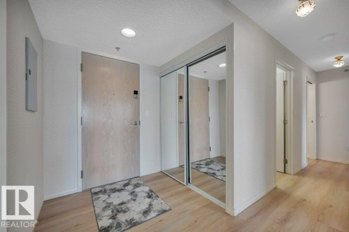 Entryway featuring wood-finish flooring, recessed lighting, and a mirrored closet with sliding doors - 316 2011 137 Avenue, Edmonton, AB - Indoor Photo Showing Other Room