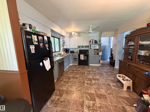 Kitchen featuring tile-patterned flooring, light-toned cabinetry, and a window above the sink - 5303 119 Avenue, Edmonton, AB 