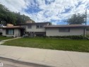 Two-story stucco exterior with brown trim and a brown shingle roof - 5303 119 Avenue, Edmonton, AB 
