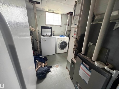 Utility area featuring a Lennox furnace, laundry appliances, and a window - 5303 119 Avenue, Edmonton, AB 