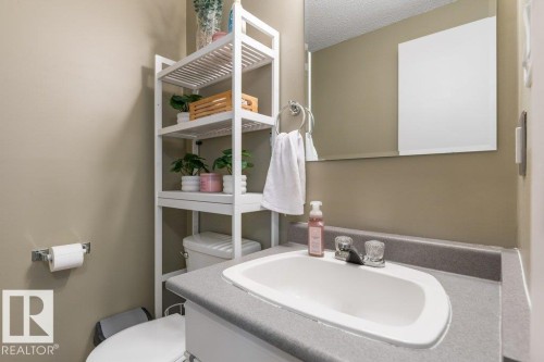 Bathroom vanity with an integrated white sink and a gray countertop - 171 Ridgewood, St. Albert, AB 