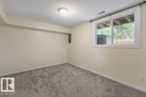Neutral-toned room featuring light beige walls and a window with a white frame - 171 Ridgewood, St. Albert, AB 