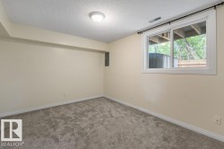 Neutral-toned room featuring light beige walls and a window with a white frame - 