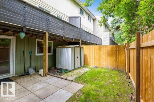 Private backyard featuring a patio with concrete pavers, grassy area, and a new wood fence - 171 Ridgewood, St. Albert, AB 