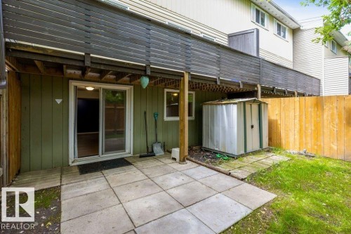 Ground-level concrete patio featuring a sliding glass door entry - 171 Ridgewood, St. Albert, AB 