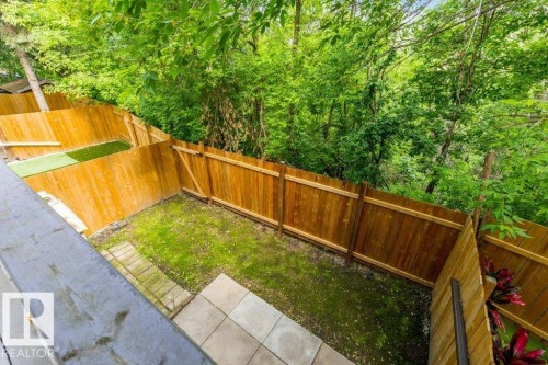 Fenced yard space with a combination of natural grass and artificial turf areas - 171 Ridgewood, St. Albert, AB 