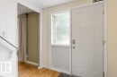 White paneled entry door with frosted sidelight - 171 Ridgewood, St. Albert, AB 