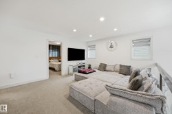 White walls with recessed lighting, carpet flooring, multiple windows with blinds, and a partial hallway opening - 