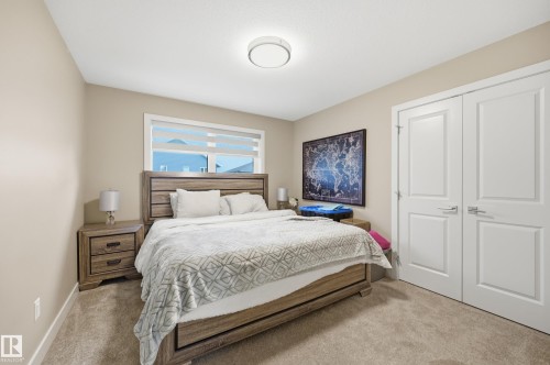 Bedroom featuring neutral wall paint and carpeting, with a ceiling-mounted light fixture - 76 Jacobs Close, St. Albert, AB 