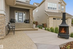 Front facade featuring horizontal siding and stacked stone accents - 