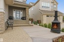 Front facade featuring horizontal siding and stacked stone accents - 76 Jacobs Close, St. Albert, AB 