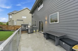 Concrete patio featuring a glass-paneled railing - 