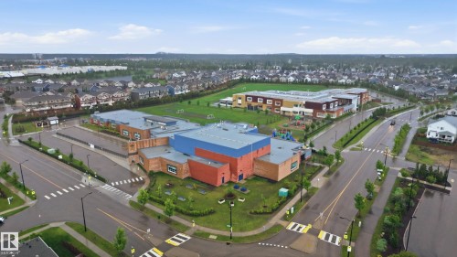 Modern institutional building with multi-colored facades, surrounded by structured landscaping - 76 Jacobs Close, St. Albert, AB 