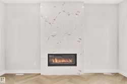 Contemporary fireplace featuring a white and gold veined surround - 