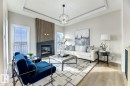 Living area featuring a modern fireplace with a dark tile surround and a wood-slat accent wall - 519 Ashgrove Circle, Leduc, AB 