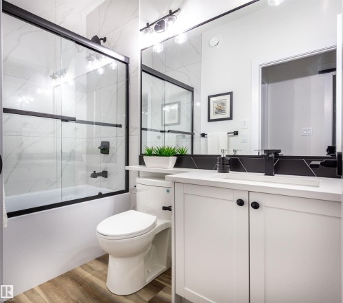 Bathroom with a white vanity featuring shaker-style doors and black hardware - 519 Ashgrove Circle, Leduc, AB 