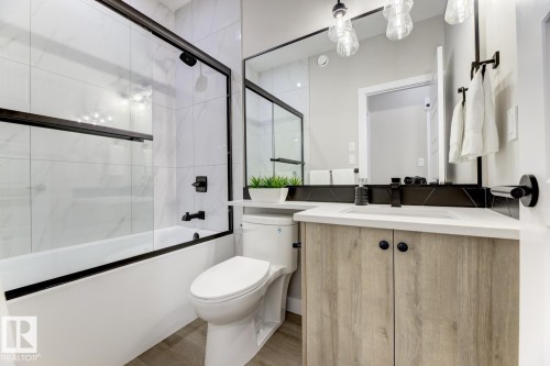 Bathroom featuring a light wood-finish vanity with a white countertop and integrated sink - 519 Ashgrove Circle, Leduc, AB 