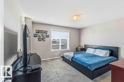 Carpeted room with a ceiling-mounted light fixture, light gray wall paint, and white trim - 1908 25 Street, Edmonton, AB 