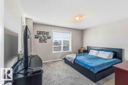 Carpeted room with a ceiling-mounted light fixture, light gray wall paint, and white trim - 