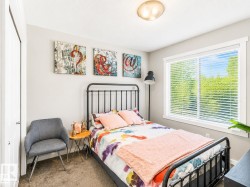 Bright room featuring a large window with horizontal blinds, overhead flush mount lighting, and carpeted flooring - 