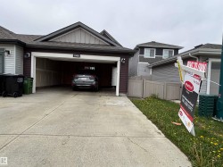 Attached two-car garage with a concrete driveway - 