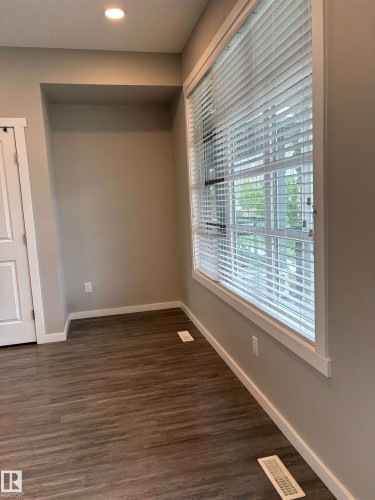 Recessed lighting, wood-finish flooring, white window blinds, and an integrated wall niche - 1908 25 Street Nw, Edmonton, AB 