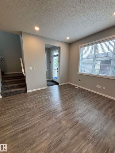 Wood-finish flooring, recessed lighting, white trim, and a carpeted staircase - 1908 25 Street Nw, Edmonton, AB 