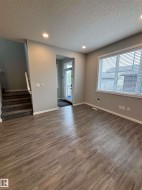 Wood-finish flooring, recessed lighting, white trim, and a carpeted staircase - 