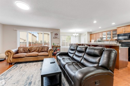 Open-concept living space featuring wood-finish flooring and recessed lighting - 3012 25 Ave Avenue, Edmonton, AB 
