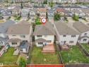Spacious backyard featuring a substantial wooden deck, green lawn, and privacy fencing - 3012 25 Ave Avenue, Edmonton, AB 