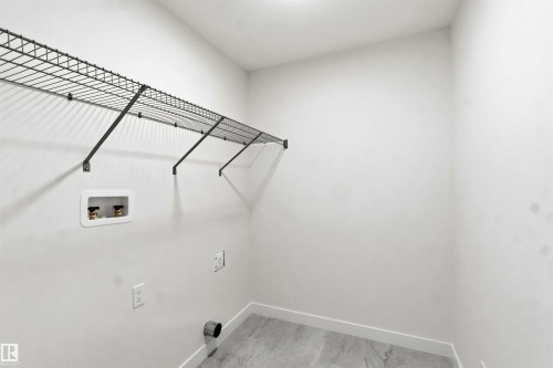 Utility space with wire shelving, light-toned wall paint, and grey-hued flooring - 1085 Cristall Crescent, Edmonton, AB 