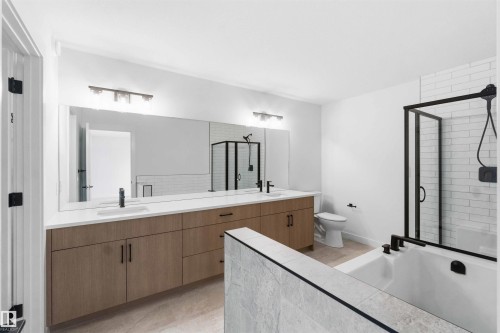 Dual vanity with light wood-finish cabinetry and white countertops - 1085 Cristall Crescent, Edmonton, AB 