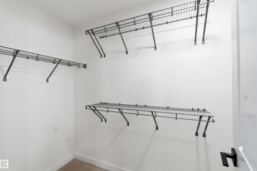 Ample storage solutions featuring multiple wire shelving units and hanging rods - 1085 Cristall Crescent, Edmonton, AB 