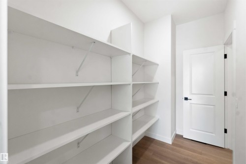Walk-in pantry featuring extensive white shelving - 1085 Cristall Crescent, Edmonton, AB 