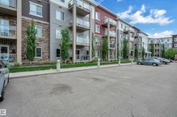 Multi-story building exterior featuring varied siding, stone accents, and private balconies with glass railings - 