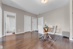 Spacious interior featuring wood-finish flooring, neutral paint tones, and white trim throughout - 