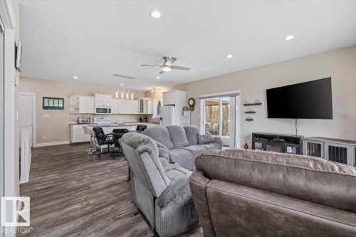 Open-concept living space featuring wood-finish flooring, recessed lighting, and a ceiling fan - 4708 47A Avenue, Onoway, AB 