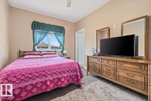 Room featuring wood-finish flooring, a neutral wall color, and a window with natural light - 4708 47A Avenue, Onoway, AB 