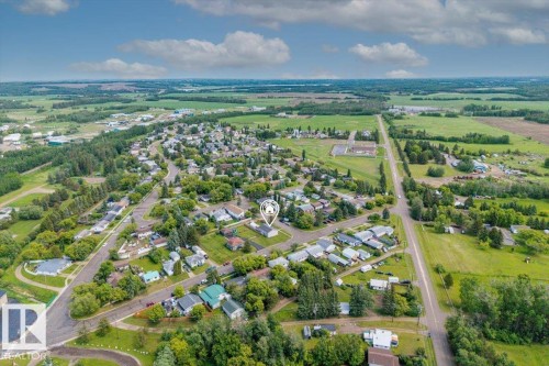 Aerial perspective showcasing a residential area amidst expansive green fields - 4708 47A Avenue, Onoway, AB 