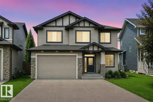 Contemporary two-story exterior with light gray siding and dark trim accents - 2517 Anderson Way, Edmonton, AB 