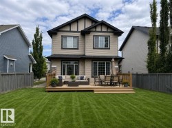 Spacious backyard featuring a large wooden deck with multiple levels - 