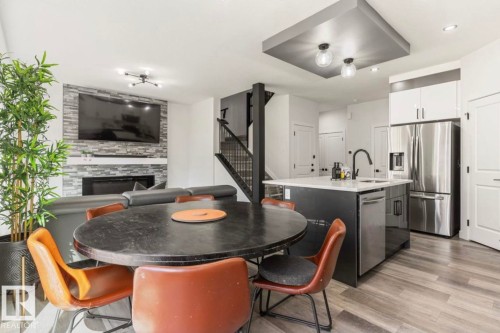 Open-concept main living area with wood-finish flooring - 19703 29 Avenue, Edmonton, AB 