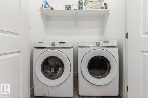 Dedicated laundry space featuring a white Samsung washer and dryer set - 19703 29 Avenue, Edmonton, AB 