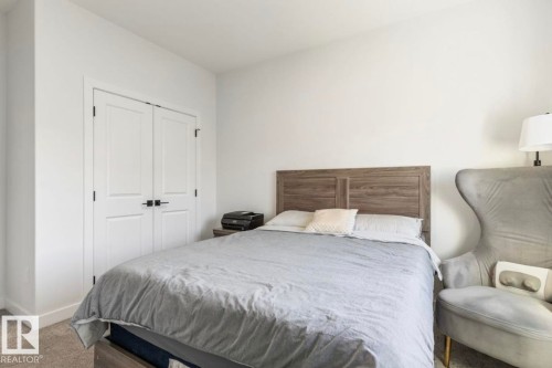 Bright interior space featuring light-toned walls, wood-finish flooring, and crisp white trim - 19703 29 Avenue, Edmonton, AB 