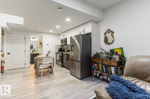 Efficiently designed living space featuring wood-finish flooring and recessed lighting - 19703 29 Avenue, Edmonton, AB 